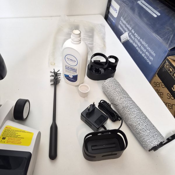 Das Zubehör vollständig ausgelegt: Ersatzwalze, Ersatzfilter, Reinigungsbürste, Messbecher, Halterungen, Reinigungsmittel.